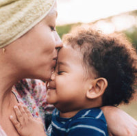 Mother kissing baby on forehead
