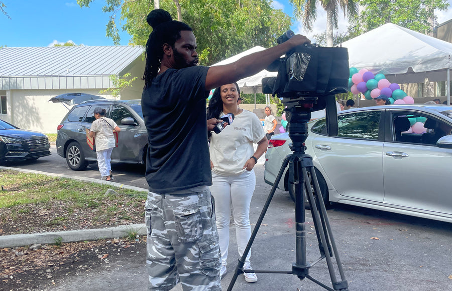 proudly team speaking to media about give back event